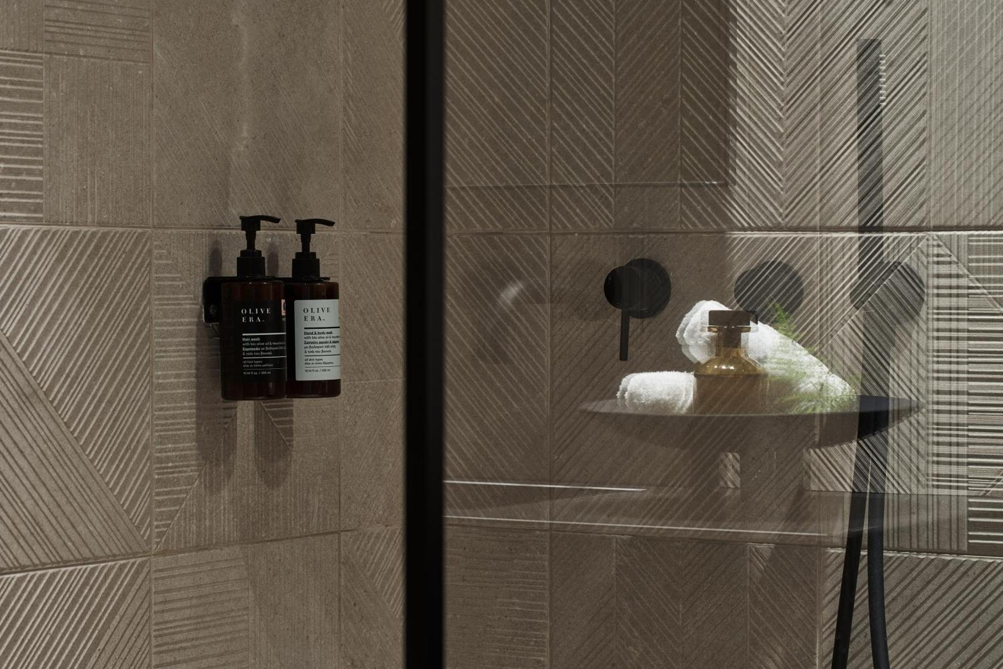 The Newel Psychiko Hotel Athens Exterior photo A shower with soap and shampoo dispensers